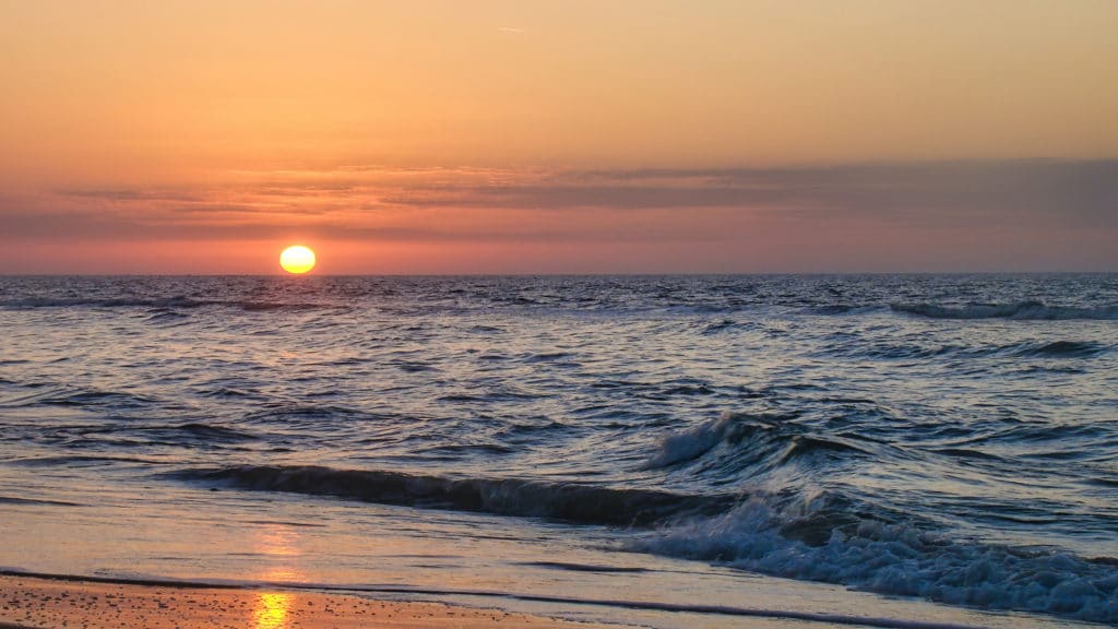 A photo of a beach at sunset
