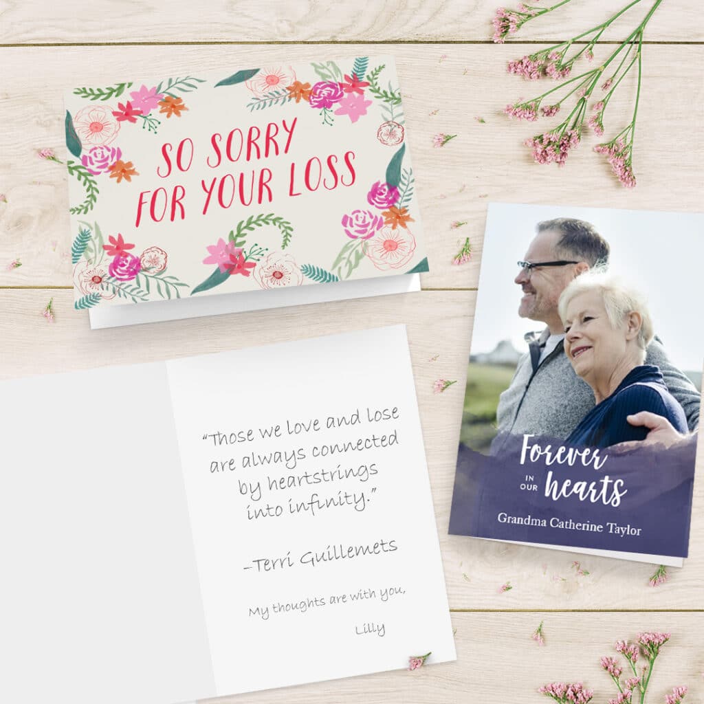 A collection of sympathy cards shown on a surface with beautiful pink flowers