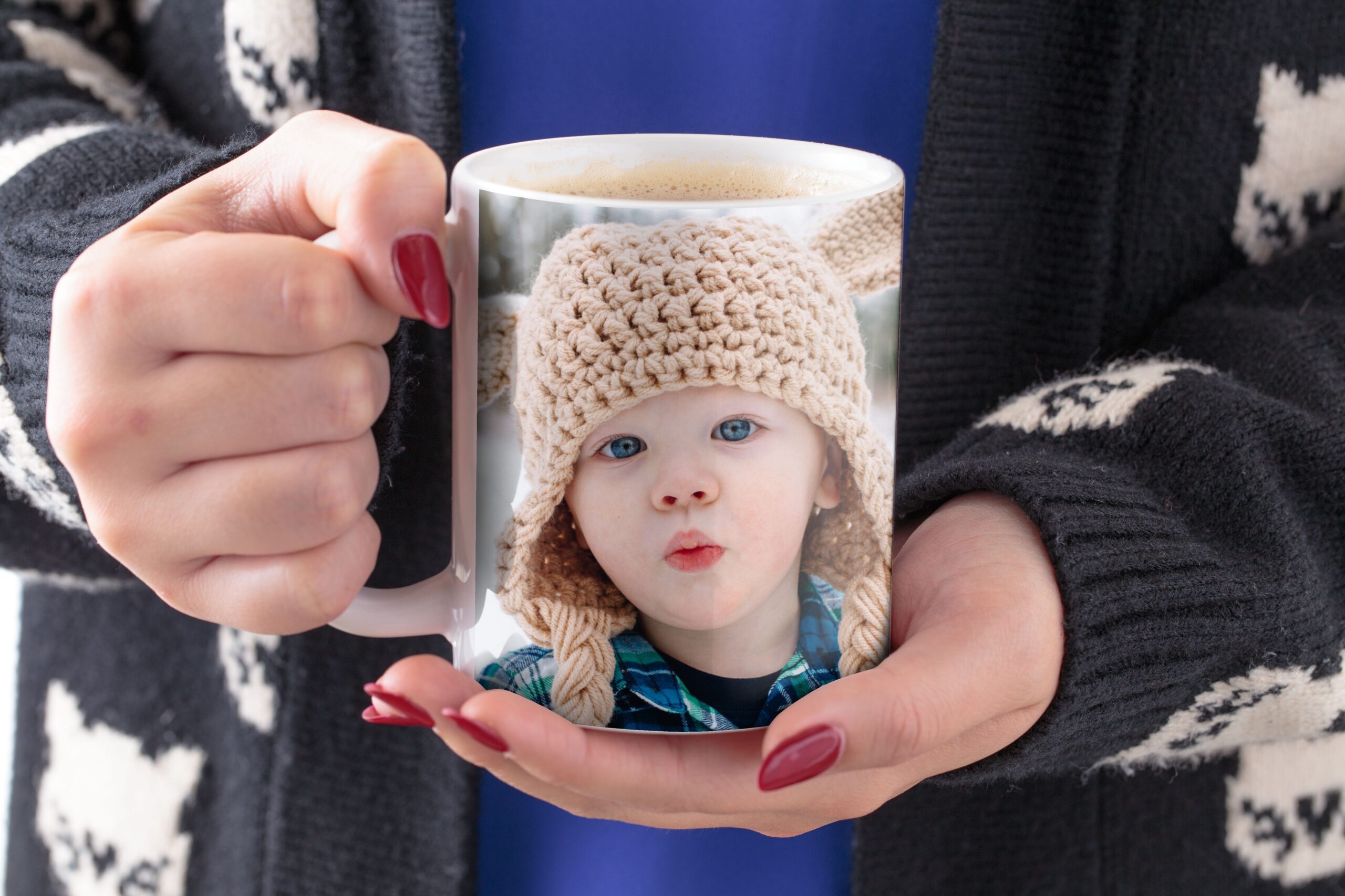 woman holding photo mug with picture of baby