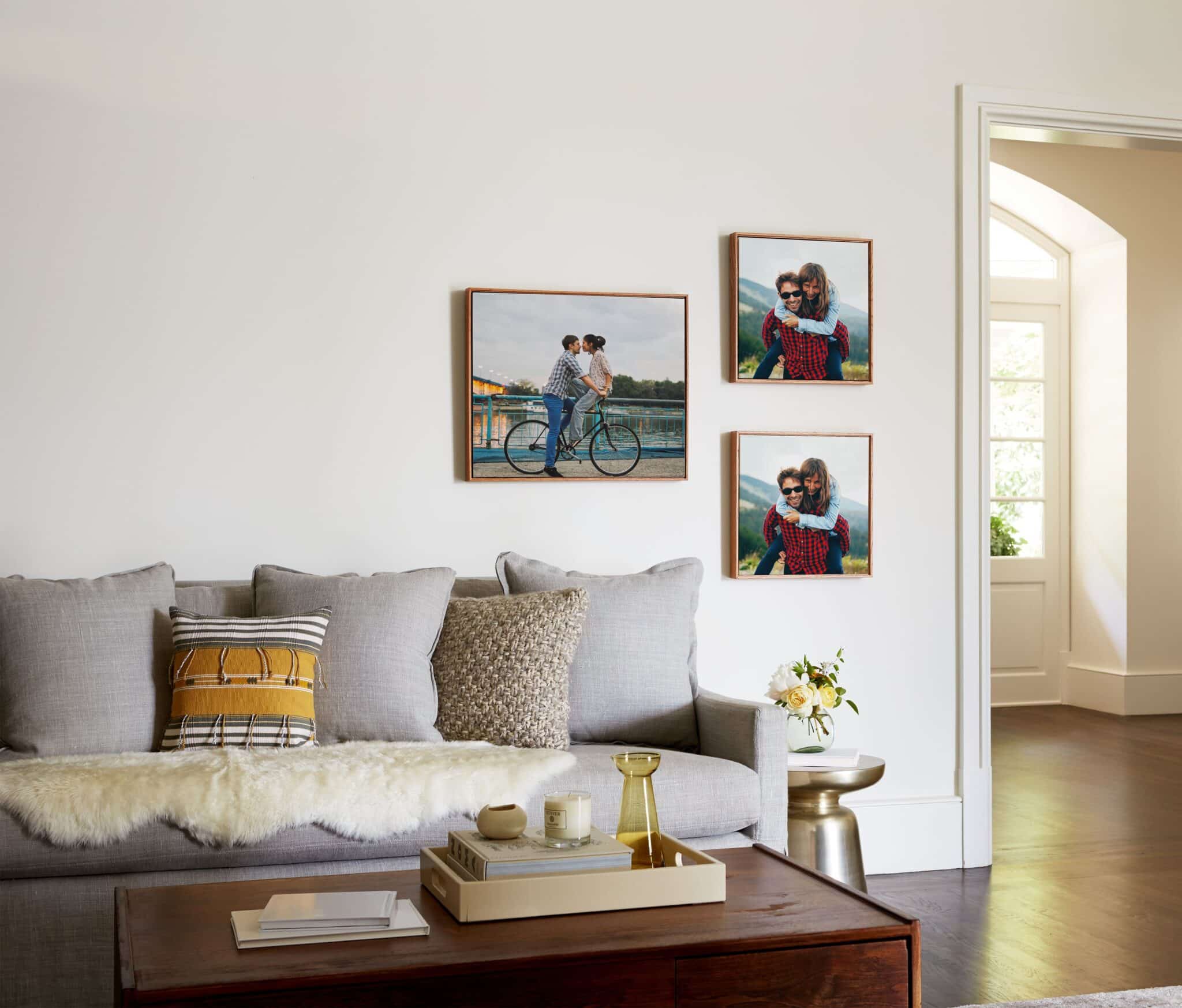 three framed canvas prints hanging on a wall above couch
